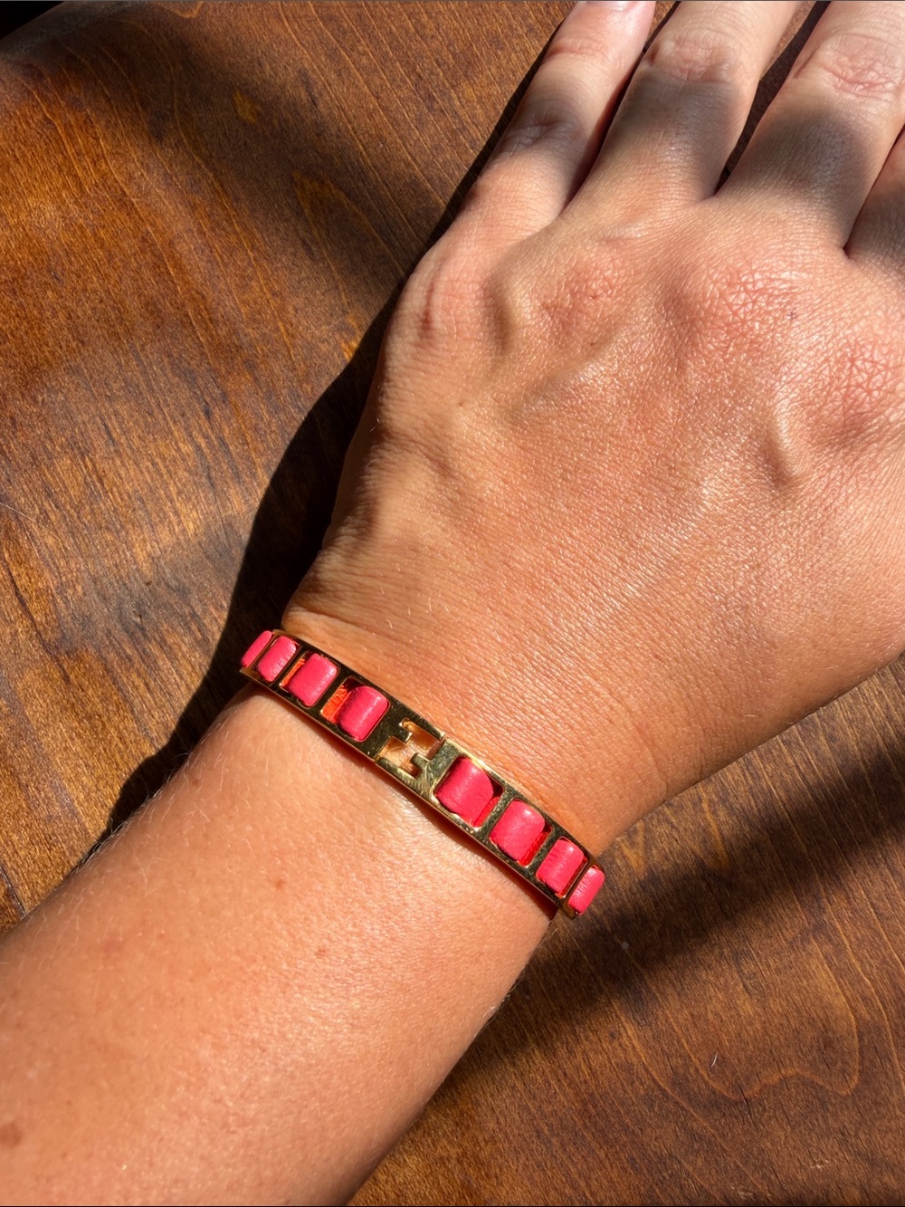 Fendi "The Fendista" bangle bracelet in gold and pink leather, featuring a hinge